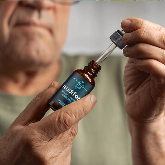 Audifort supplement bottle being handled